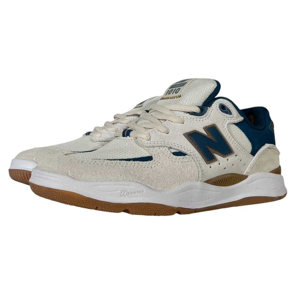 The 1010 BL Tiago Lemos Beige Blue Suede New Balance Numeric Skateboarding Shoes feature off-white mesh and suede uppers, navy blue accents, a blue N logo, and brown rubber soles—ideal for skateboarding.