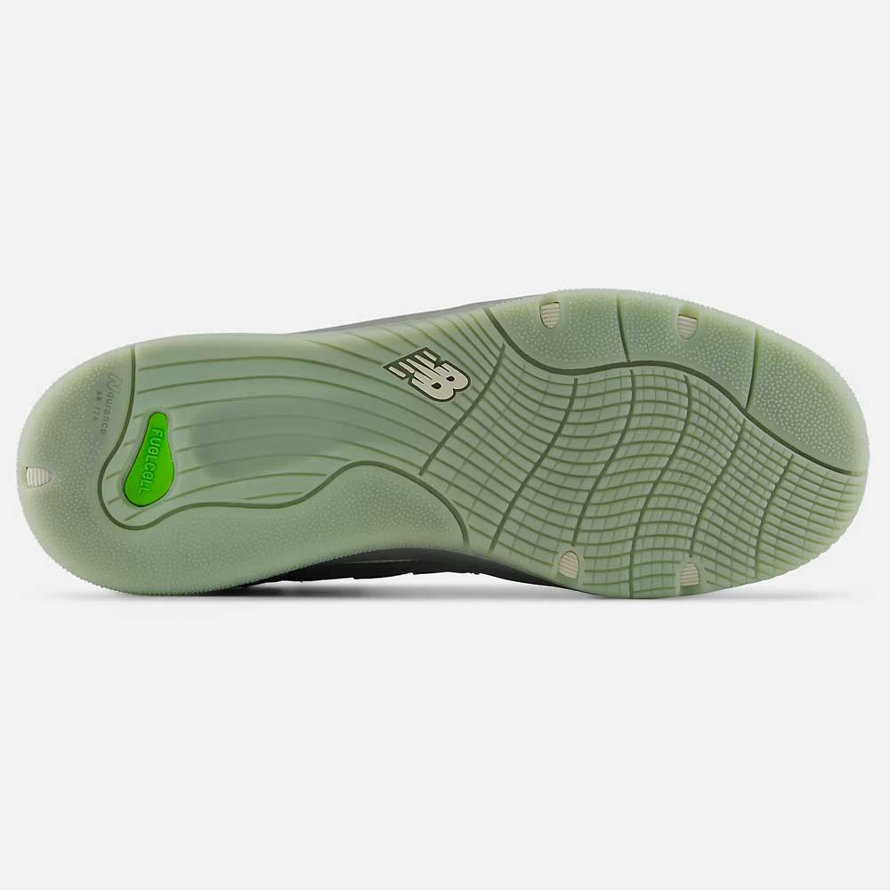 The image shows the bottom of the 1010 PS Tiago Lemos Slate Grey Sea Salt New Balance Numeric Suede Skateboarding shoe, featuring wavy grip patterns, a green insert near the heel, a durable ABZORB midsole for comfort, and an NB logo at the center.