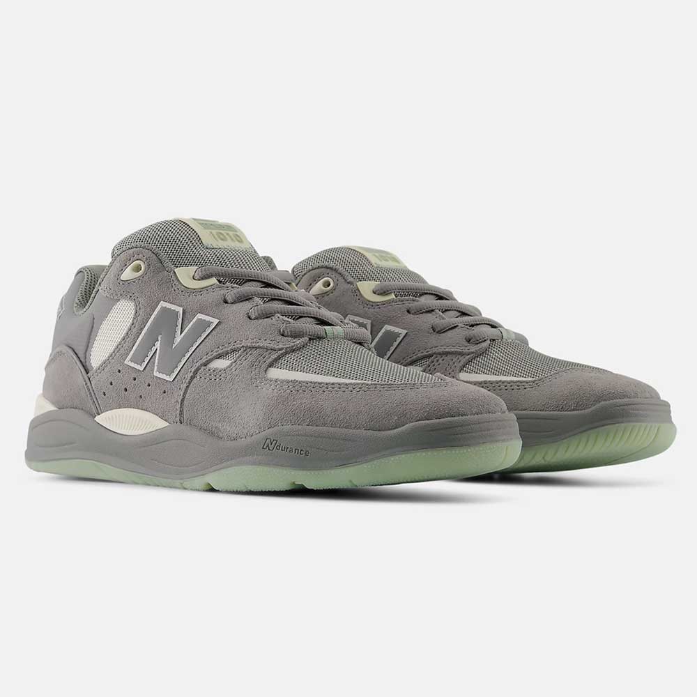 The 1010 PS Tiago Lemos Slate Grey Sea Salt New Balance Numeric Skateboarding Shoes feature gray suede and mesh uppers, light gray “N” logos, pale green outsoles, and an ABZORB midsole for comfort—designed for durability on the board.