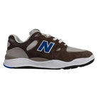 The 1010 SV Village Psychic Tiago Lemos Gray Blue Suede New Balance Numeric Skateboarding Shoes feature a brown suede and gray mesh upper, white laces, a white FuelCell midsole, blue N logo, and a black outsole with a blue heel accent.