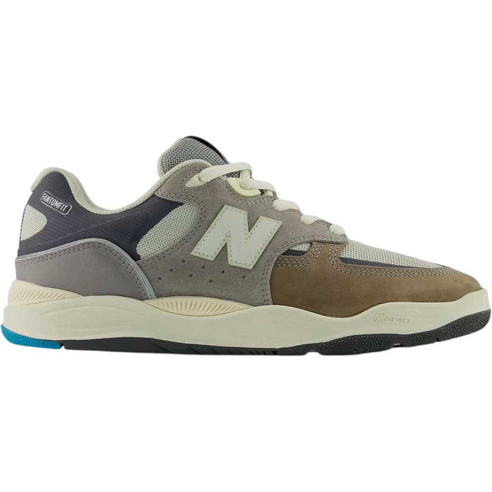 Introducing the 1010 Y Tiago Lemos Gray Day Marble Head Island Blue New Balance Numeric Suede Skateboarding Shoes—a New Balance skate sneaker from the Tiago Lemos line, designed with a mesh and suede upper in shades of gray, brown, and cream. Featuring a white “N” logo on the side, white laces, and a two-tone rubber sole detailed with blue and black accents.
