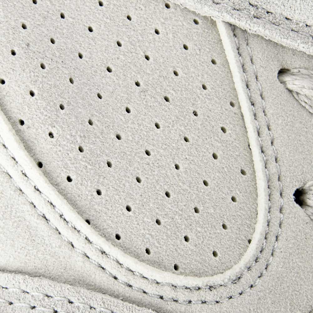 Close-up of the Accel White Leather Es Shoes Skateboarding, highlighting fine stitching and small perforated holes on the toe box for breathability.