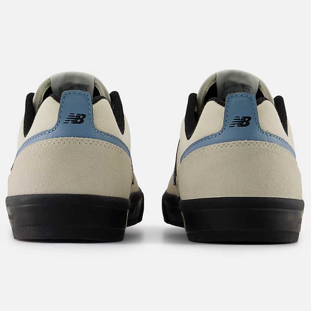 Back view of the 306 SBB Jamie Foy Sea Salt Still Water New Balance Numeric suede skateboarding shoes, featuring beige uppers, black soles, blue heel tab accents, and the signature New Balance logo—ideal for vulcanized skate shoe fans.
