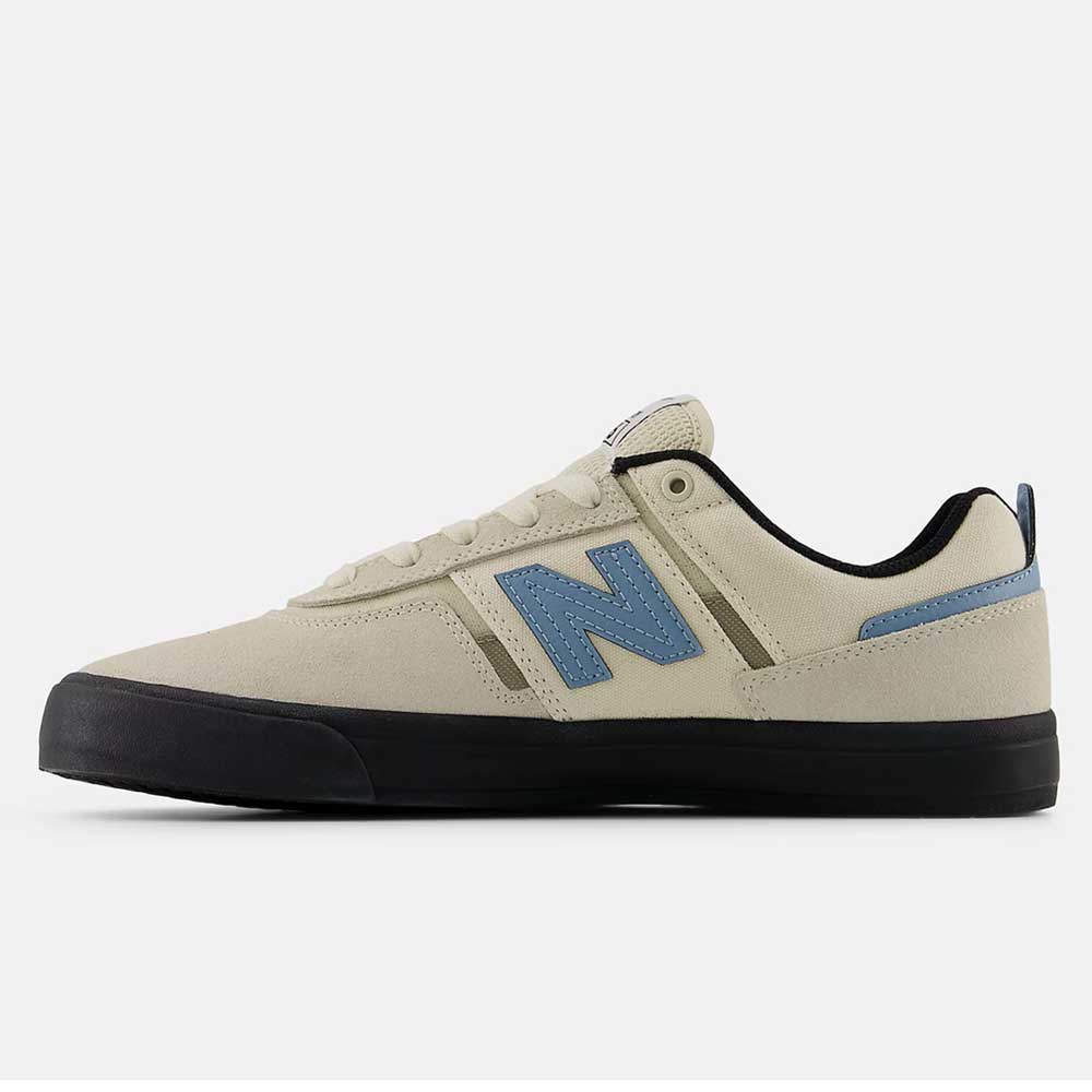 The 306 SBB Jamie Foy Sea Salt Still Water New Balance Numeric Suede Skateboarding Shoe is shown from the side, featuring a beige upper, blue N logo, black sole and trim, and blue heel detail against a plain white background.
