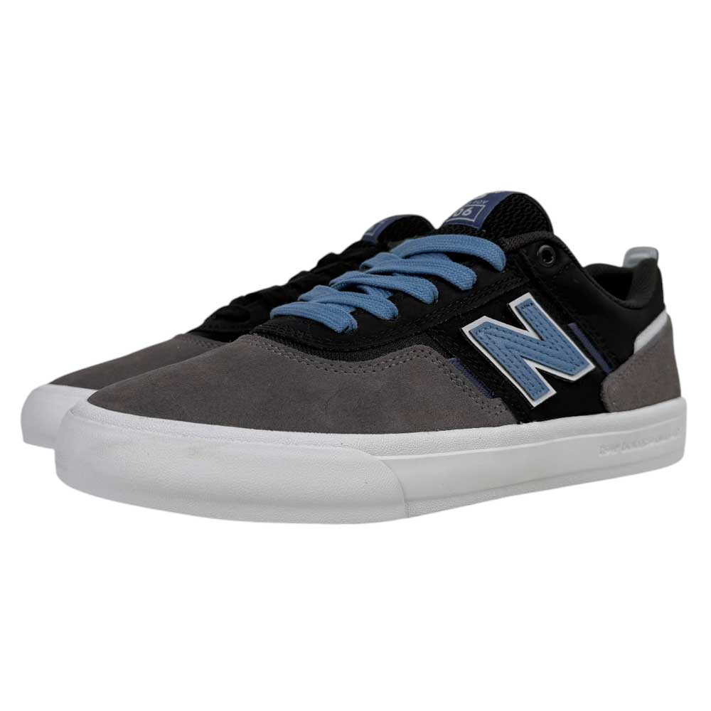 The 306 TRI New Balance Numeric Jamie Foy Suede Shoes in Grey Black feature gray suede toes, black uppers, light blue laces, a white sole, and a bold light blue "N" logo on the side—ideal skate shoes for style and performance.