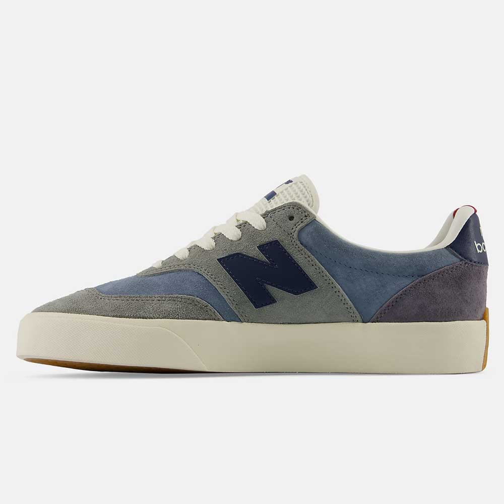 A side profile view displays the New Balance Numeric 340 NBA Gray Blue Green suede skateboarding shoes, featuring a gray and blue colorway with white laces, a navy "N" logo on the side, a cream-colored sole, and reinforced toe cap for impact protection.