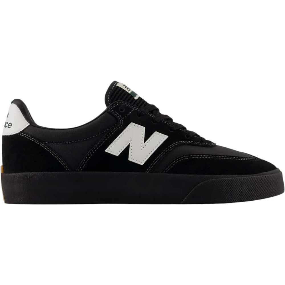 The 340 YRW Black White New Balance Numeric Suede Skateboarding Shoes, shown in a side view on a white background, feature impact protection for enhanced comfort during every step. These sneakers are black with a white N logo on the side, white heel detail, and a black sole.