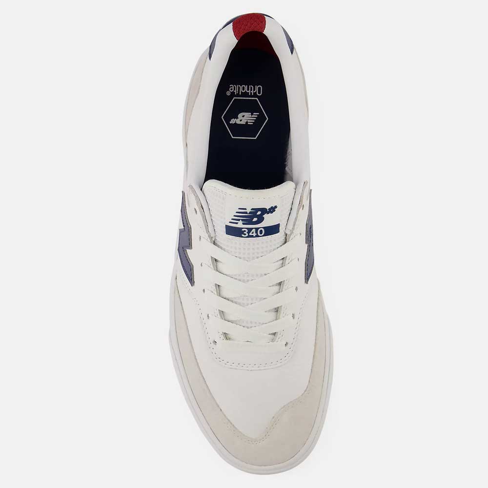 Top view of the 340 YRW New Balance Numeric Suede Skateboarding Shoe in white with blue accents, featuring a reinforced toe cap for added impact protection and white laces. The vulcanized skate shoe displays a dark blue New Balance logo on the side, with “340” marked on the tongue, shown against a plain white background.