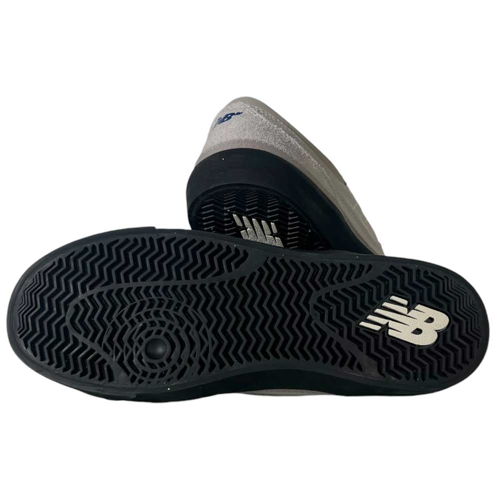 A pair of 417 LSB Franky Villani Grey Black Suede New Balance Numeric Skateboarding Shoes, with one shoe on its side and the other revealing the black sole with a white NB logo and textured tread pattern.