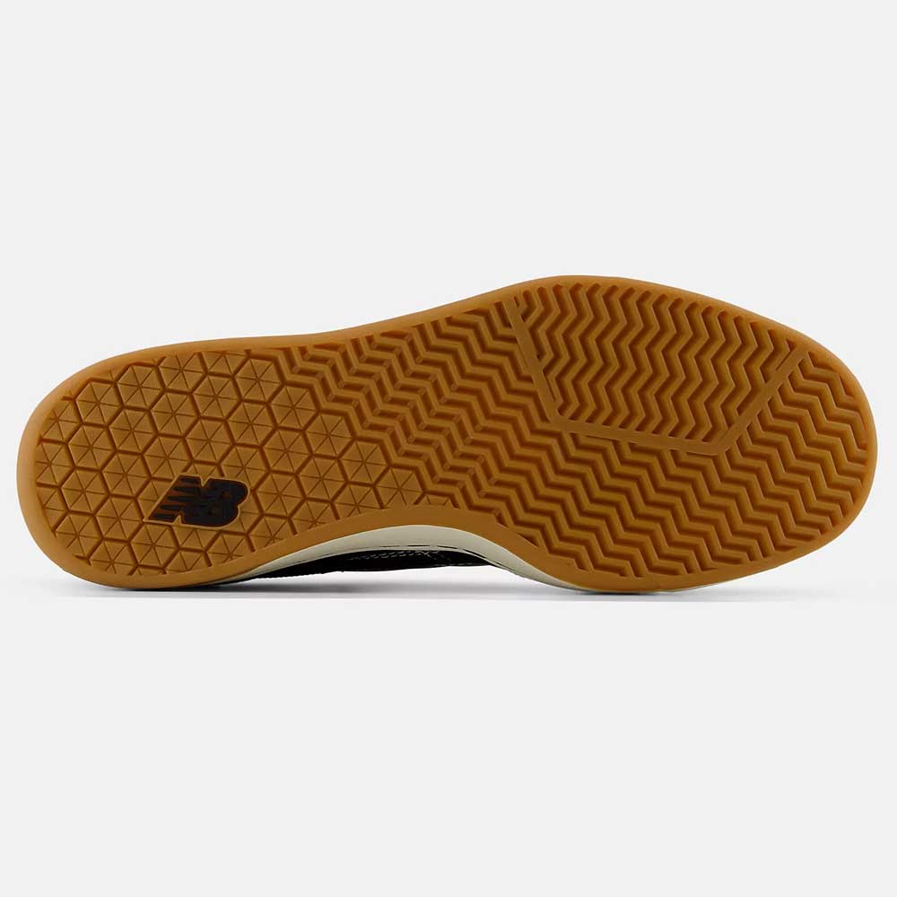 Close-up of the durable gum rubber sole on the New Balance Numeric 440 BCO Black White Suede Skateboarding Shoes, featuring hexagonal and herringbone tread patterns, New Balance logo, and an ABZORB midsole for comfort.