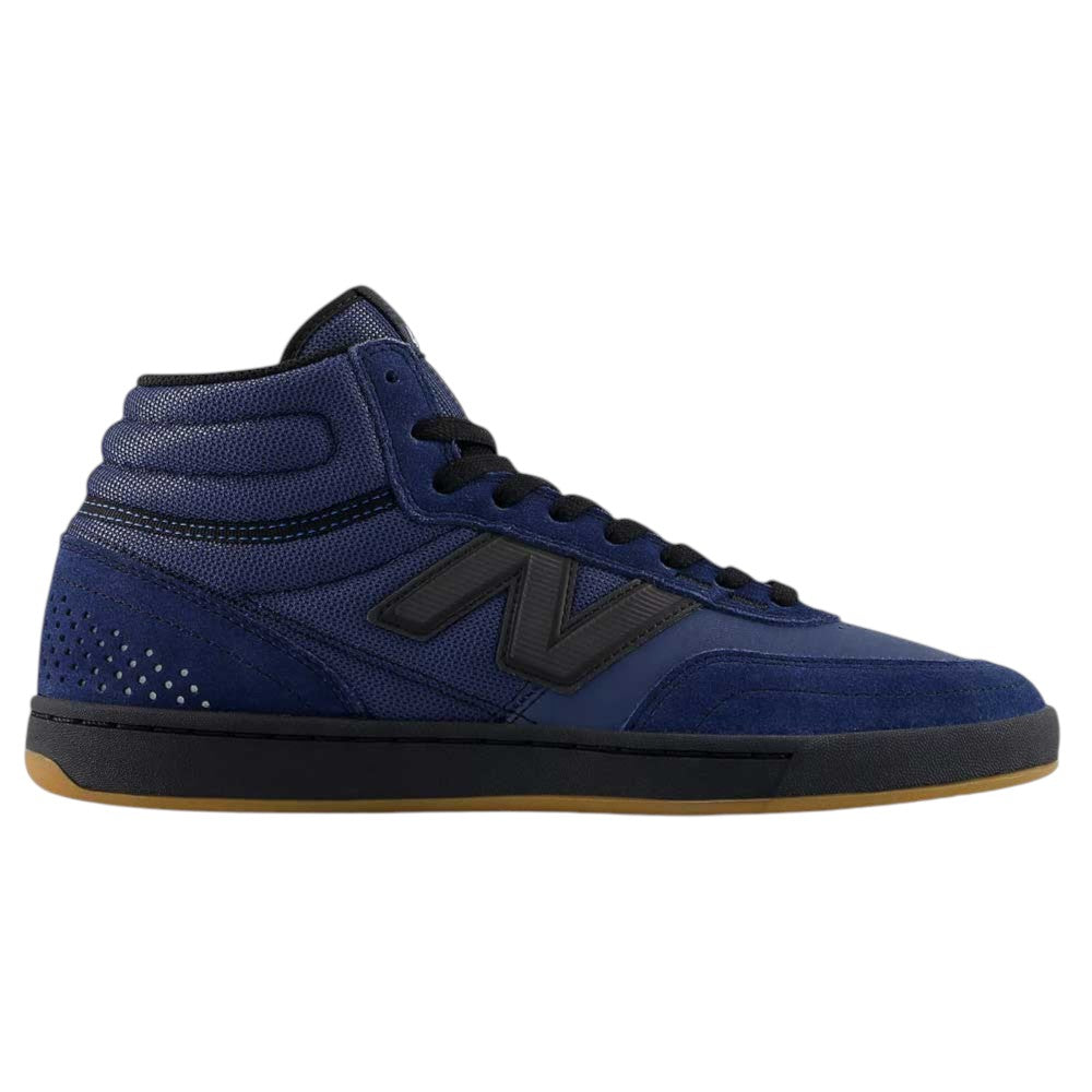 The Vintage Indigo Black 440 HNN New Balance Numeric Suede Skateboarding Shoes feature a navy blue high-top silhouette with black laces, a black N logo, suede and mesh accents, and a light brown rubber sole—displayed in a side profile—for a durable design inspired by classic skate shoe construction.