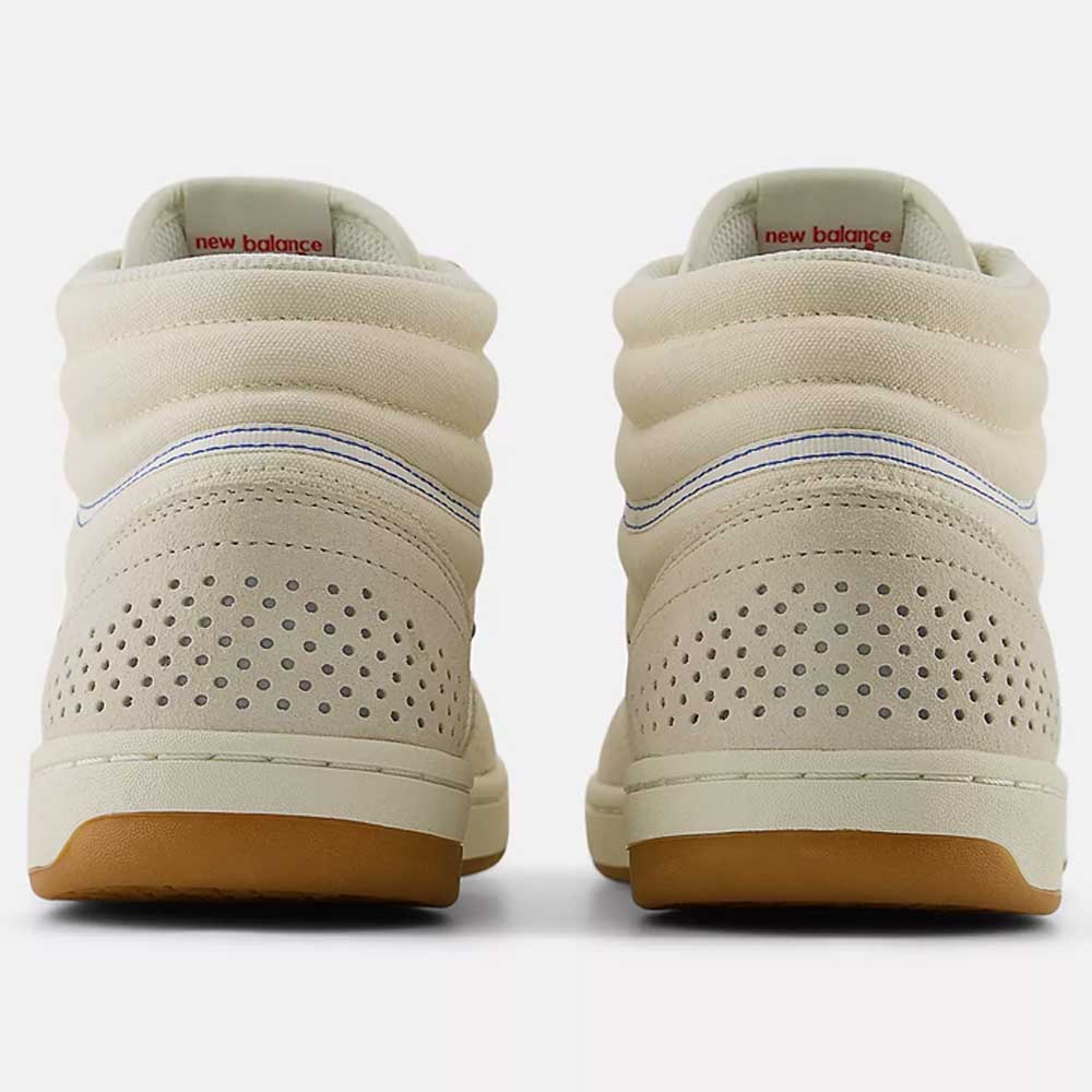 The 440 HTW Timberwolf White New Balance Numeric Suede Skateboarding Shoes are shown from the back, featuring a gum rubber sole, perforated heels, padded collars, ABZORB midsole, and visible New Balance logos on the inner heels.