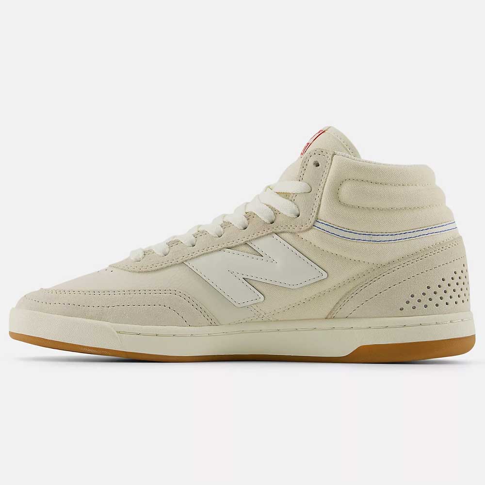The 440 HTW Timberwolf White New Balance Numeric Suede Skateboarding Shoe is a beige high-top with a white N logo, perforated heel, gum sole, ABZORB midsole, and blue ankle stitching, viewed from the side on a white background.