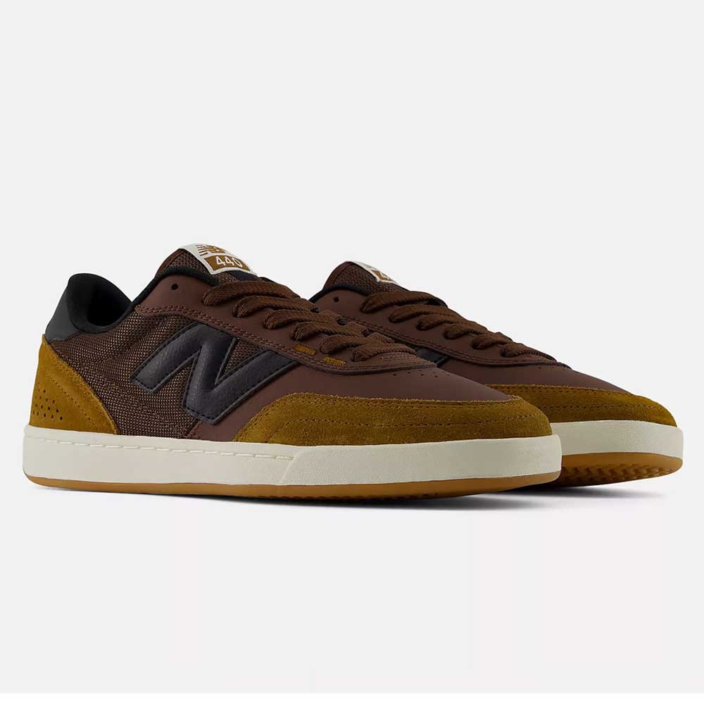 A pair of 440 PRB Pumpernickle Black New Balance Numeric Suede Skateboarding Shoes in brown and mustard yellow with black accents and white soles, featuring a durable NDurance rubber outsole and an ABZORB midsole for enhanced comfort, displayed on a plain white background.