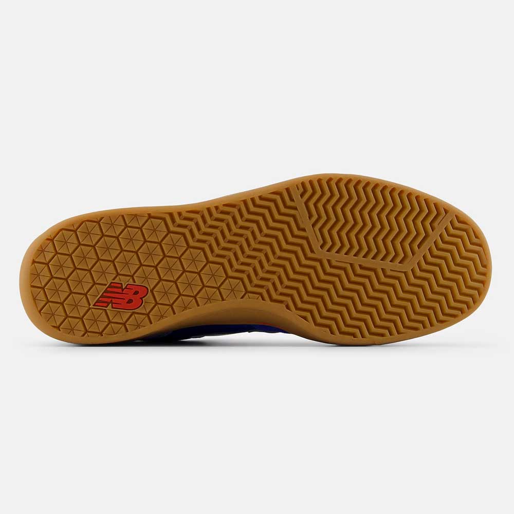 The image shows the gum rubber sole of the 440 RTB Blue Gum New Balance Numeric Suede Skateboarding Shoes featuring a deep zigzag and geometric tread for grip, with a red New Balance logo near the heel.