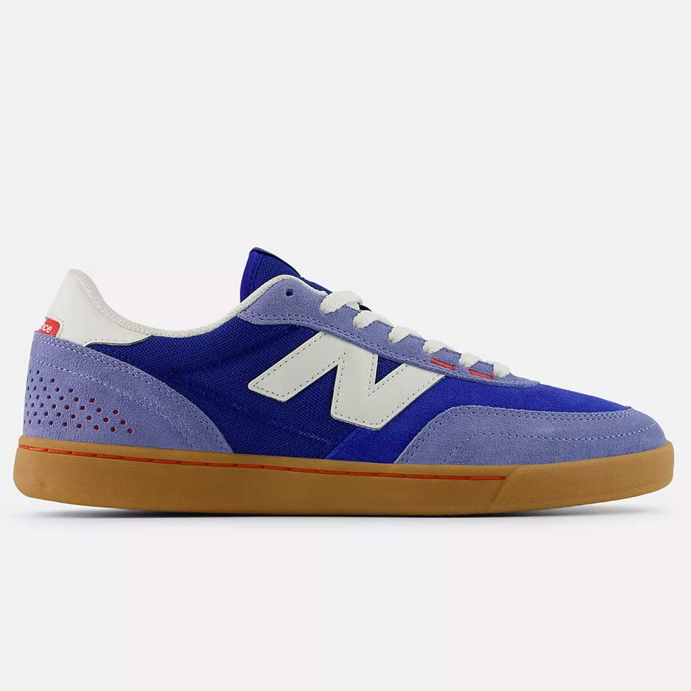 A side view of the 440 RTB Blue Gum New Balance Numeric Suede Skateboarding Shoe in blue and purple, featuring a white "N" logo, white laces, red heel accent, perforated back detail, ABZORB midsole, and a light brown gum sole.