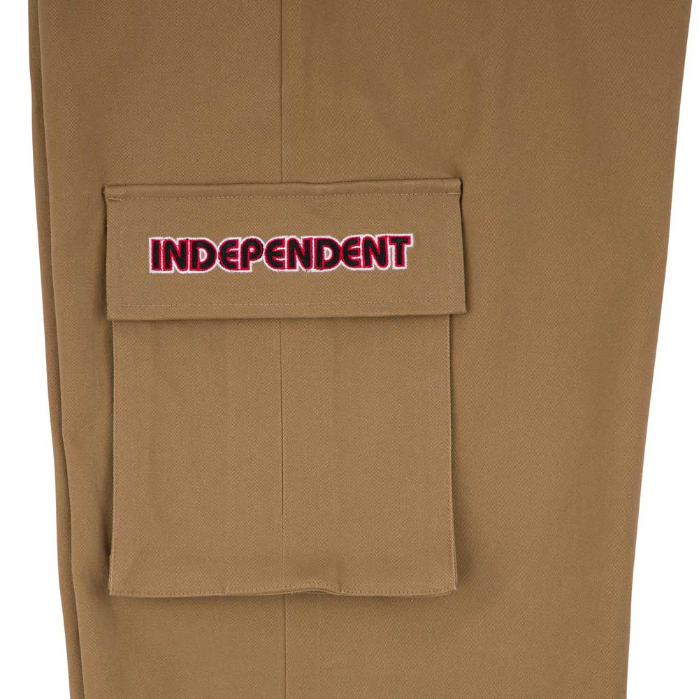A close-up of the 44643574 Groundwork Cargo Pants in dark khaki ripstop shows a pocket with a flap, embroidered with INDEPENDENT in red and white, capturing classic cargo pants style for men.