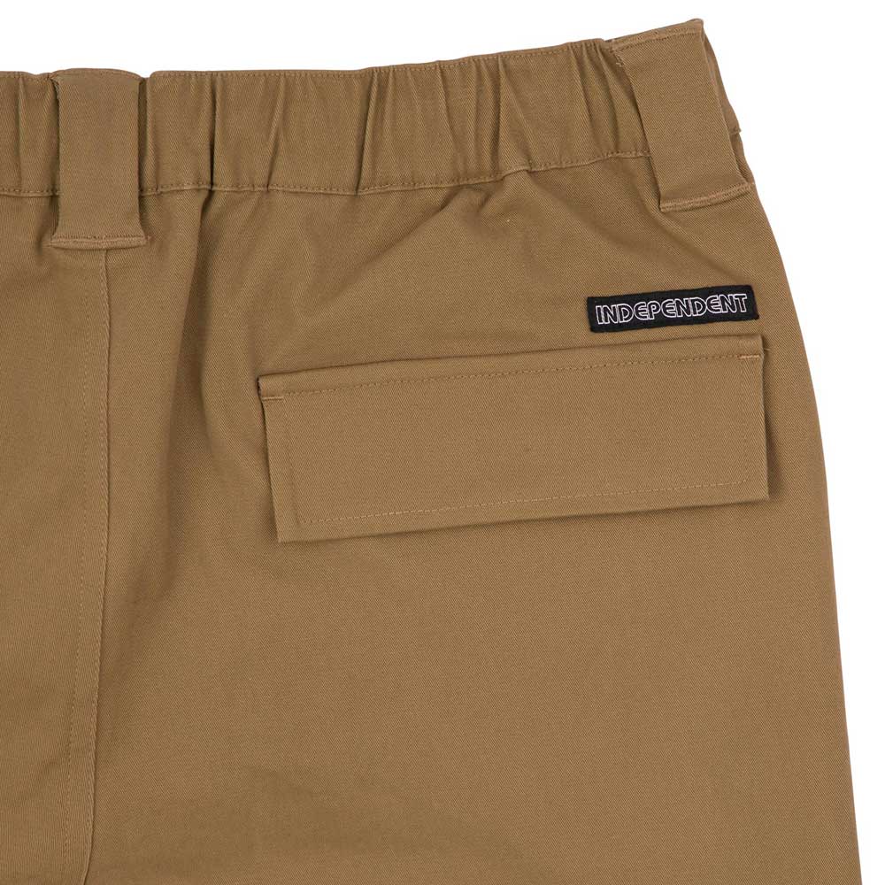 Close-up of 44643574 Groundwork Cargo Pants in dark khaki ripstop, featuring an elastic waistband, rectangular flap pocket, and a black "INDEPENDENT" patch above the pocket.