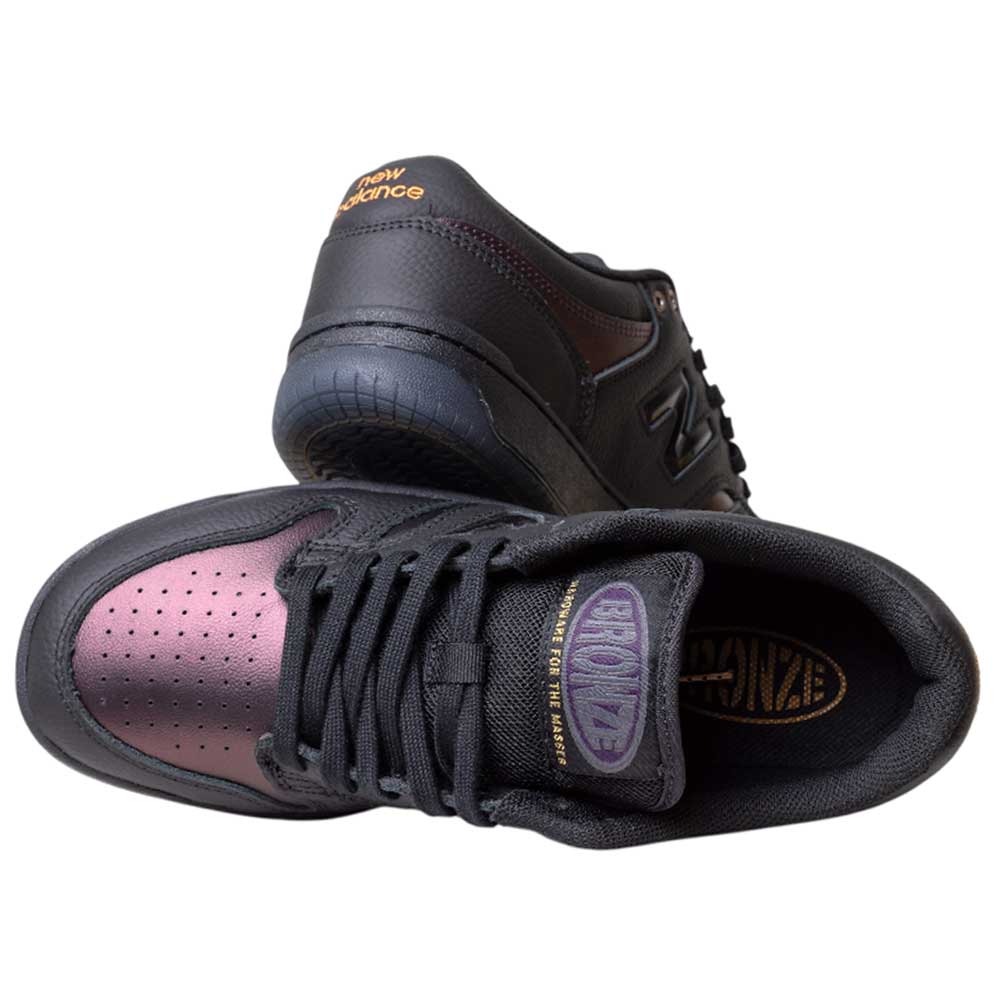 The 480 BFK Bronze 56K New Balance Numeric Skateboarding Shoes feature a suede black iridescent upper, bronze detailing, gold New Balance branding on the tongue and heel, and durable construction for lasting style.