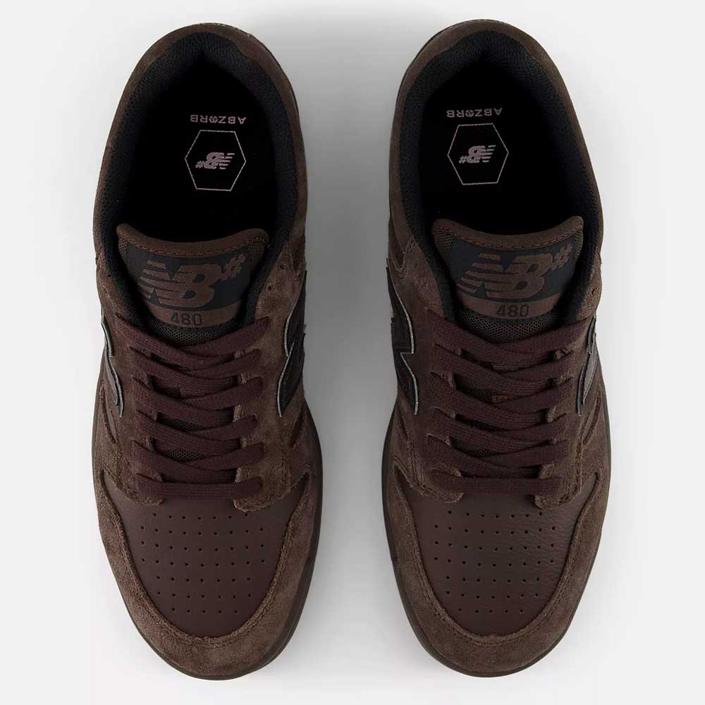 Top-down view of a pair of Chocolate Brown 480 CHC New Balance Numeric suede skateboarding shoes with leather details, black interiors, and the New Balance logo visible on each tongue.