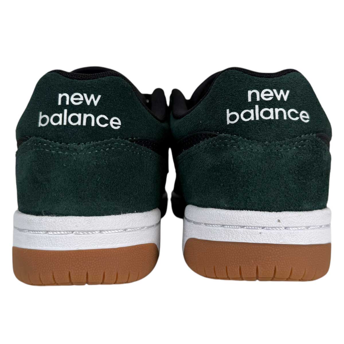 A rear view of the 480 FOY New Balance Numeric Shoes in suede green and black, featuring white heel branding, durable uppers, white midsoles, and brown rubber outsoles against a plain background.