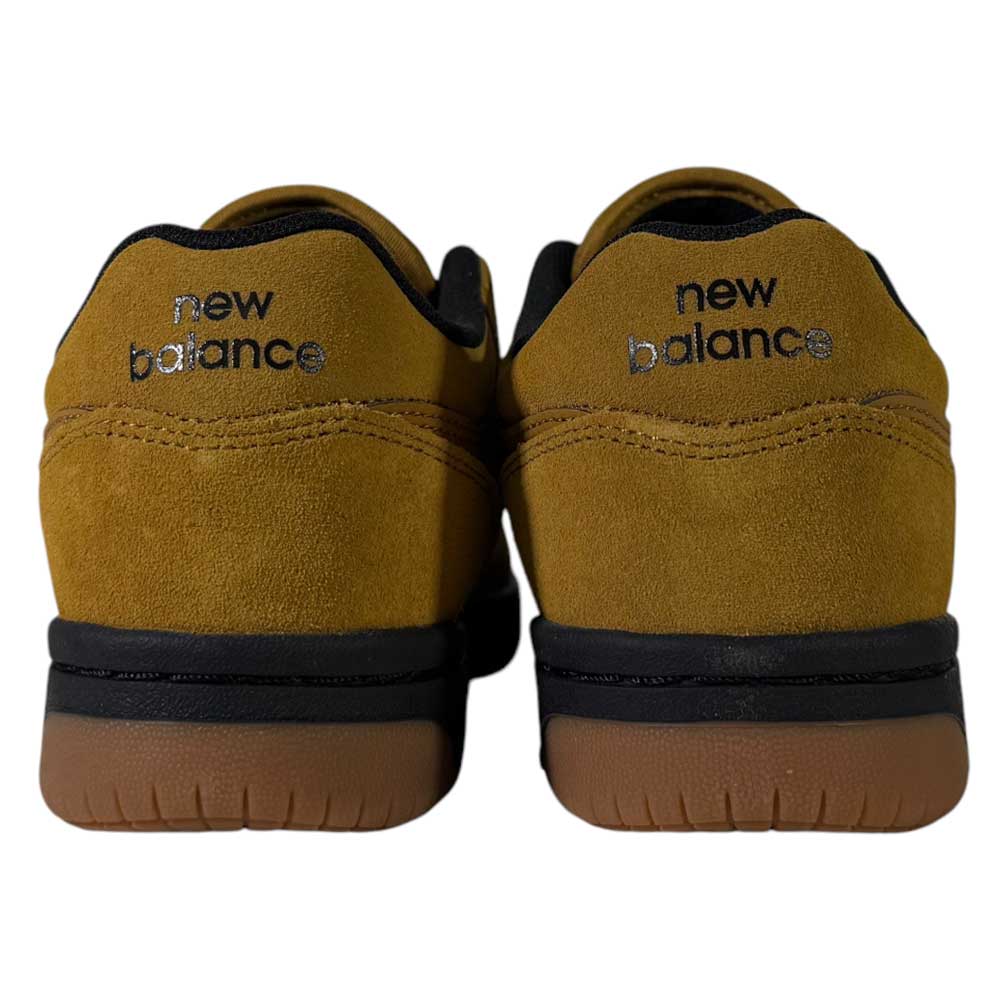 A pair of 480 GDT New Balance Numeric Shoes in suede wheat and black, shown from the back, featuring black New Balance logos on each heel above black and brown rubber soles.