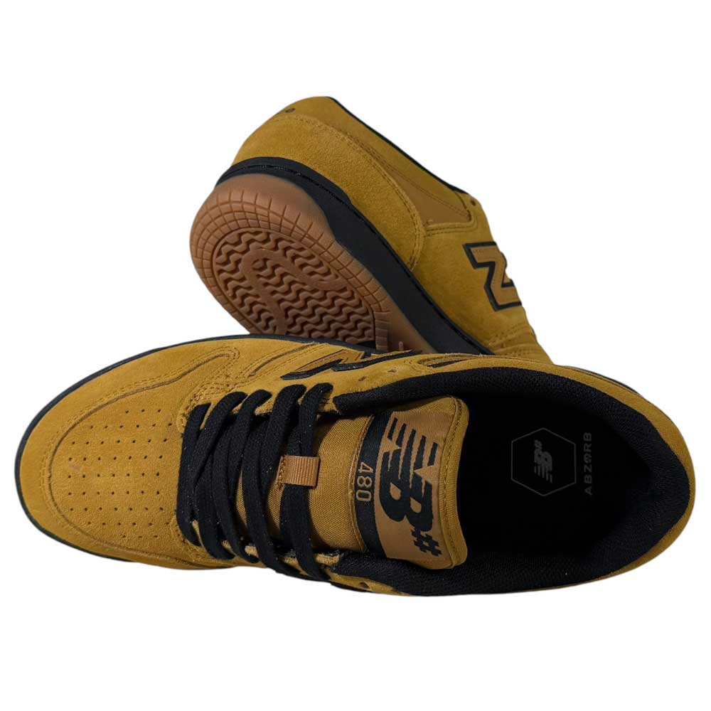 A pair of 480 GDT New Balance Numeric Shoes in Suede Wheat Black with black laces and gum soles—one upright to show the top and side, the other on its side highlighting the sole, durable suede, and inner lining.