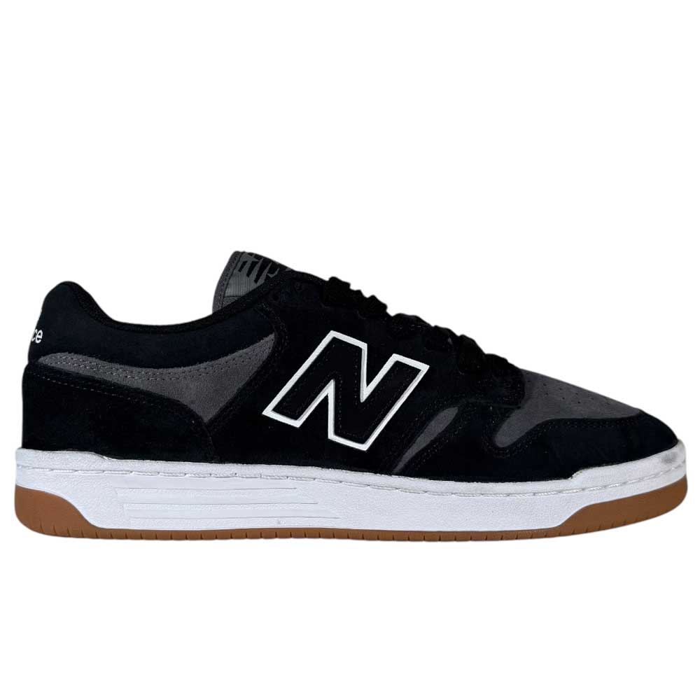 The 480 MGC New Balance Numeric Shoes in Suede Black Dark Grey feature a white N logo, white midsole, and gum rubber outsole with a durable leather upper, shown in a side profile view.