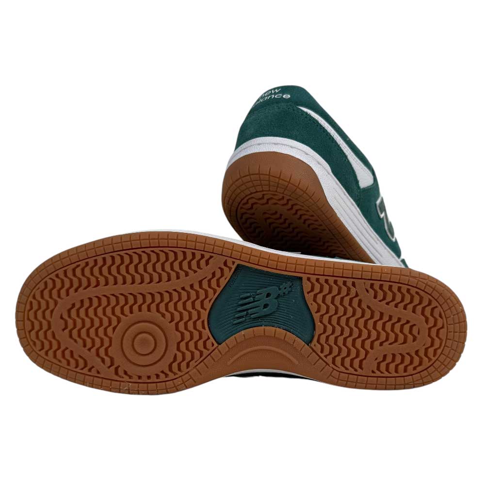 A pair of 480 NDI New Balance Numeric Skateboarding Shoes in green suede and white, one upright and one on its side, featuring a durable upper, gum rubber outsole with wavy tread, and central NB logo.