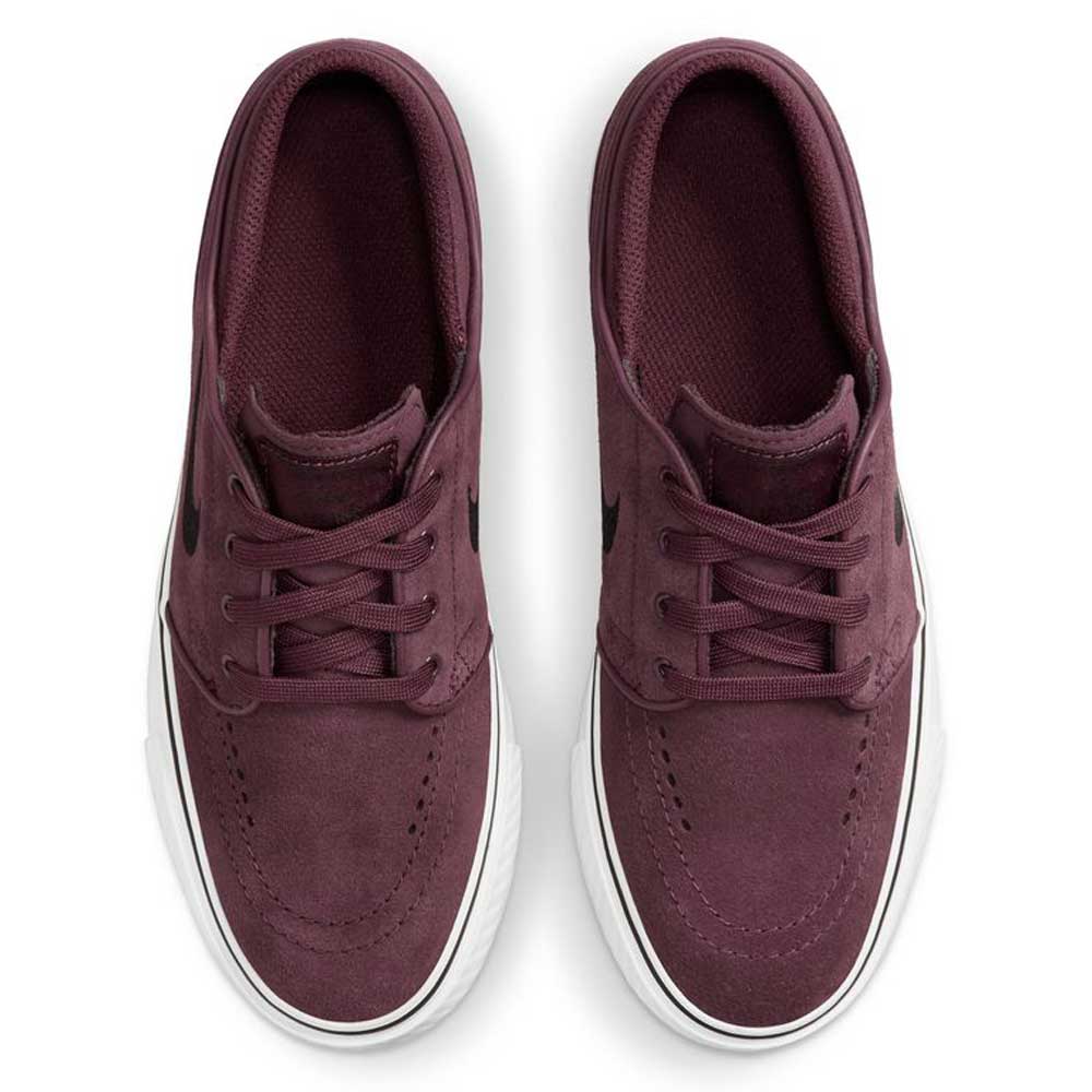 A pair of Nike SB 525104607 Burgundy Crush Black Janoski OG suede skateboarding shoes with white soles, laces, black Swoosh logos on the sides, and Zoom Air cushioning, viewed from above.