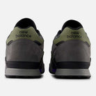 A pair of 770VWX Grey Olive Purple New Balance Numeric suede skateboarding shoes with olive green heel tabs, black New Balance logos, grey suede uppers, and a black and grey sole for style and court stability.