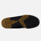 The image shows the sole of a 770YZZ Black White New Balance Numeric Suede Skateboarding Shoe, featuring a tan and black rubber outsole with textured, grooved patterns for grip and stability, plus visible branding near the heel.