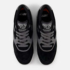 Top view of black and gray 770YZZ Black White New Balance Numeric Suede Skateboarding Shoes featuring "new balance" and "Made in England" on the tongue, gray laces, and white midsoles—perfect for skateboarding court stability.