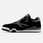Side view of the 770YZZ Black White New Balance Numeric Suede Skateboarding Shoes featuring a black and gray upper, gray N logo, white midsole, and gum rubber outsole for court stability against a plain white background.