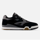The 770YZZ Black White New Balance Numeric Suede Skateboarding Shoe features a black and gray design, white sole, light gray laces, gum outsole accents, and side New Balance logo, seen from the left.