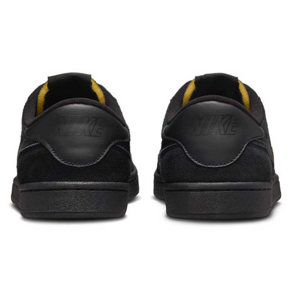 A pair of 909096002 Black Vivid Orange FC Classic Nike SB Suede Skateboarding Shoes seen from the back, featuring embossed Nike logos on the heel, vivid orange interior accents, and a cushioned Solarsoft insole for comfort.