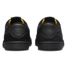 A pair of 909096002 Black Vivid Orange FC Classic Nike SB Suede Skateboarding Shoes seen from the back, featuring embossed Nike logos on the heel, vivid orange interior accents, and a cushioned Solarsoft insole for comfort.