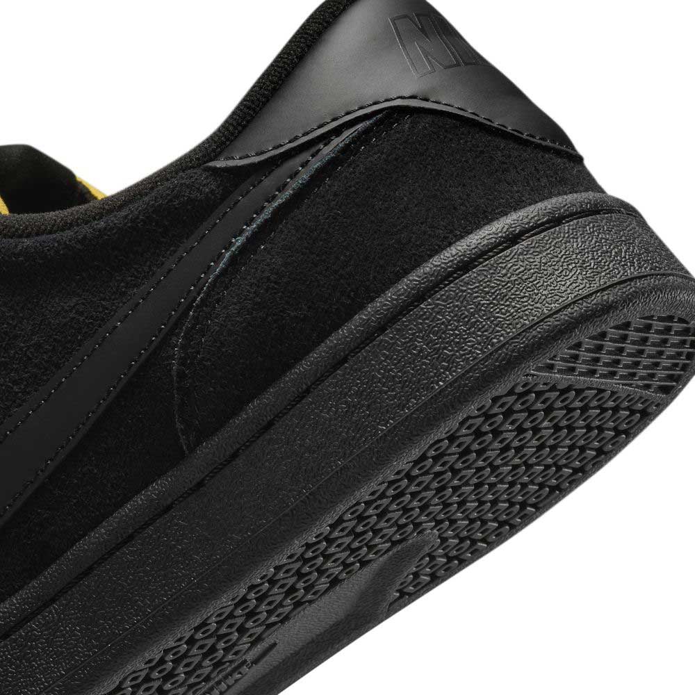 Close-up of the heel and sole of the 909096002 Black Vivid Orange FC Classic Nike SB suede skateboarding shoes, featuring a textured rubber outsole, black suede heel detail, and a comfortable Solarsoft insole.