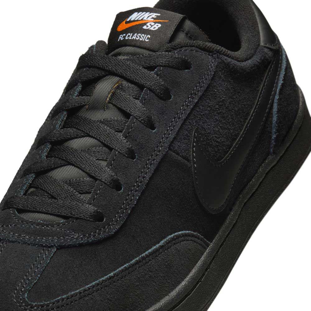 Close-up of the 909096002 Black Vivid Orange FC Classic Nike SB suede skateboarding shoe, featuring a black suede and leather upper, black laces, an orange Nike SB logo on the tongue, and a Solarsoft insole.
