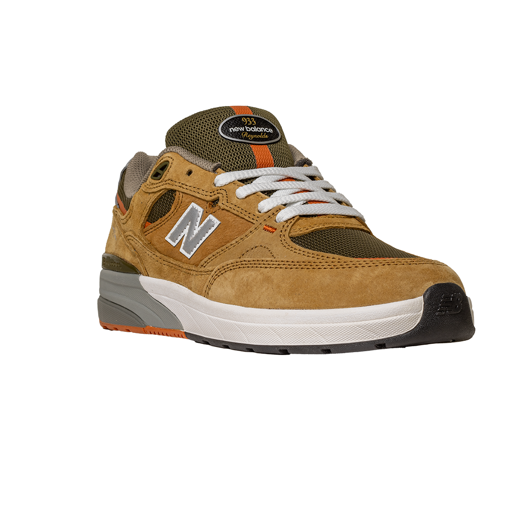 The 933 MNO Andrew Reynolds Brown Grey New Balance Numeric Skateboarding Shoes Suede feature tan and olive green suede, white laces, orange accents, and a white, gray, and black sole, shown on a plain white background.