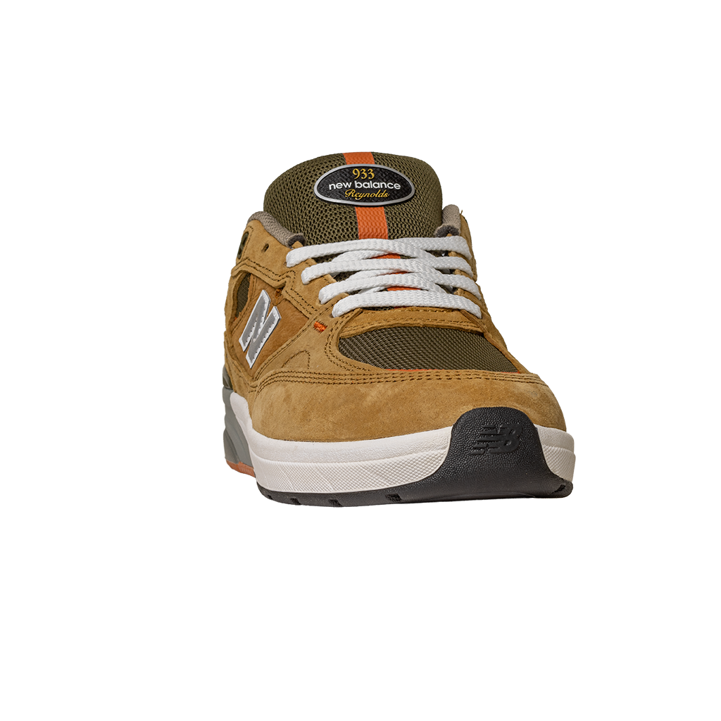 A front view of the brown and grey New Balance Numeric 933 MNO Andrew Reynolds skateboarding shoes, featuring suede details, white laces, and a black, white, and gray sole inspired by classic skate style.