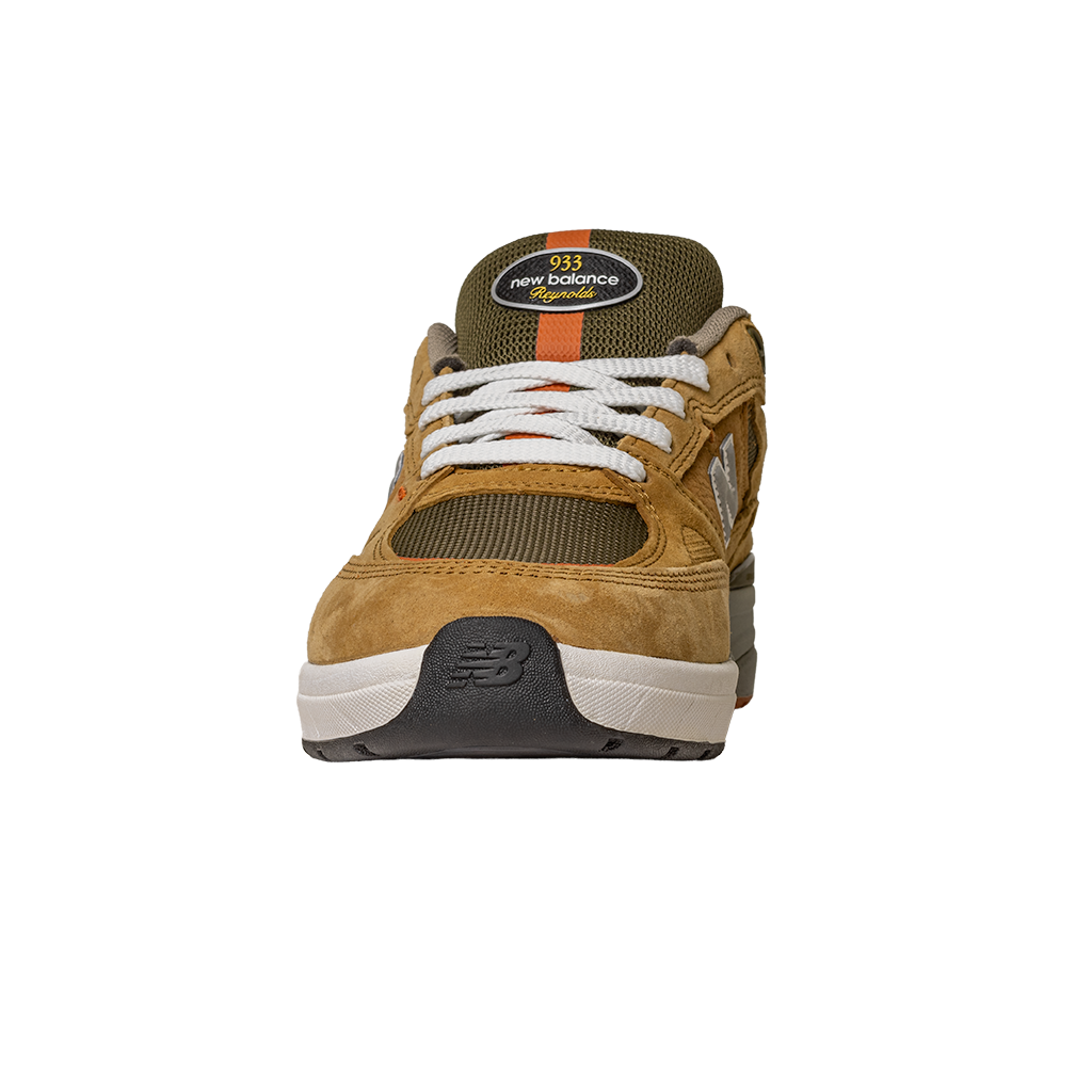 The 933 MNO Andrew Reynolds Brown Grey New Balance Numeric Skateboarding Shoe is shown from the front, featuring white laces, mesh fabric, suede overlays, and the brand’s logo on the tongue.