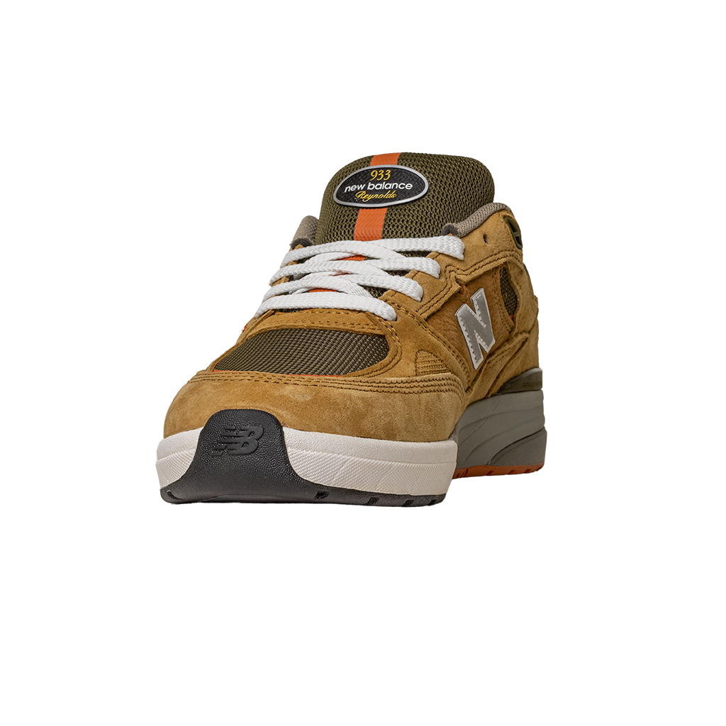 The 933 MNO Andrew Reynolds Brown Grey New Balance Numeric Skateboarding Shoes feature suede overlays, mesh panels, white laces, and a gray and black sole, showcased from the front against a plain white background.