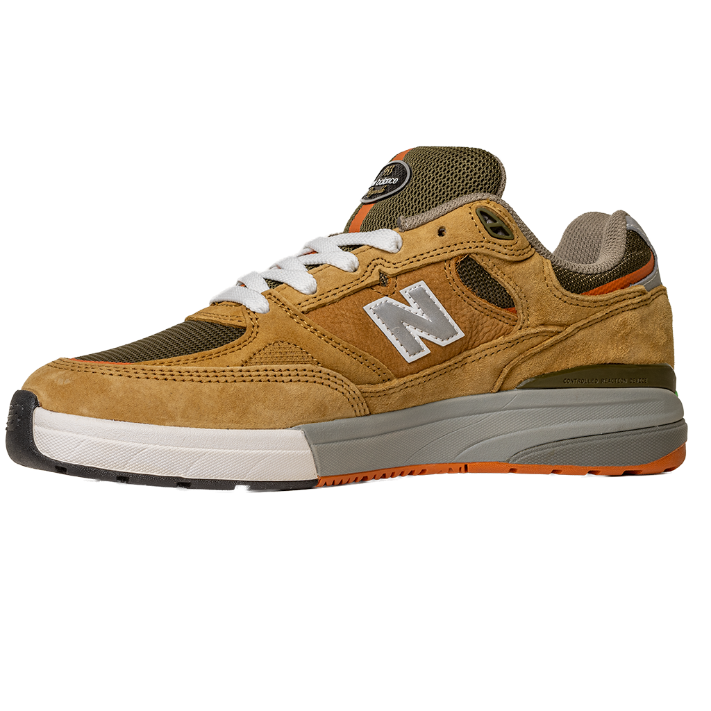 The 933 MNO Andrew Reynolds Brown Grey New Balance Numeric Skateboarding Shoes feature brown and tan suede, white laces, a grey midsole, orange outsole, and white "N" logo, shown on a plain white background.
