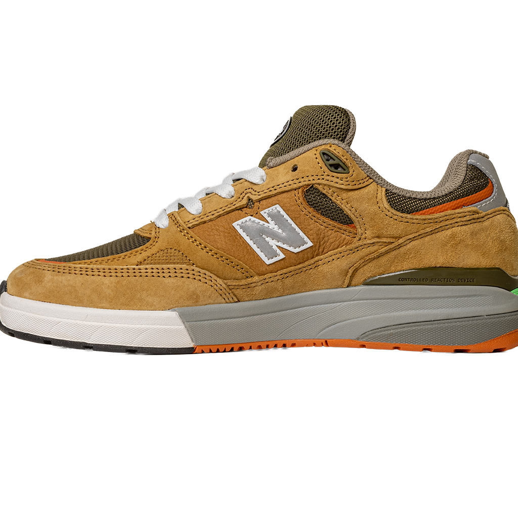 The 933 MNO Andrew Reynolds Brown Grey New Balance Numeric Skateboarding Shoes feature suede material, white laces, a silver N logo, and orange accents on the sole and heel, all displayed on a white background.