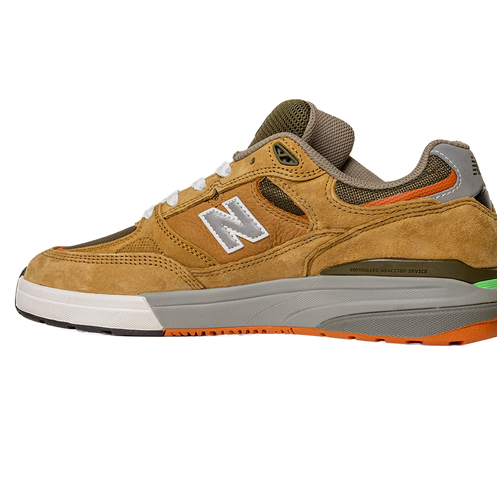The 933 MNO Andrew Reynolds Brown Grey New Balance Numeric Skateboarding Shoes Suede feature a white N logo, orange and green accents, white laces, and a brown and orange outsole, displayed on a plain white background.