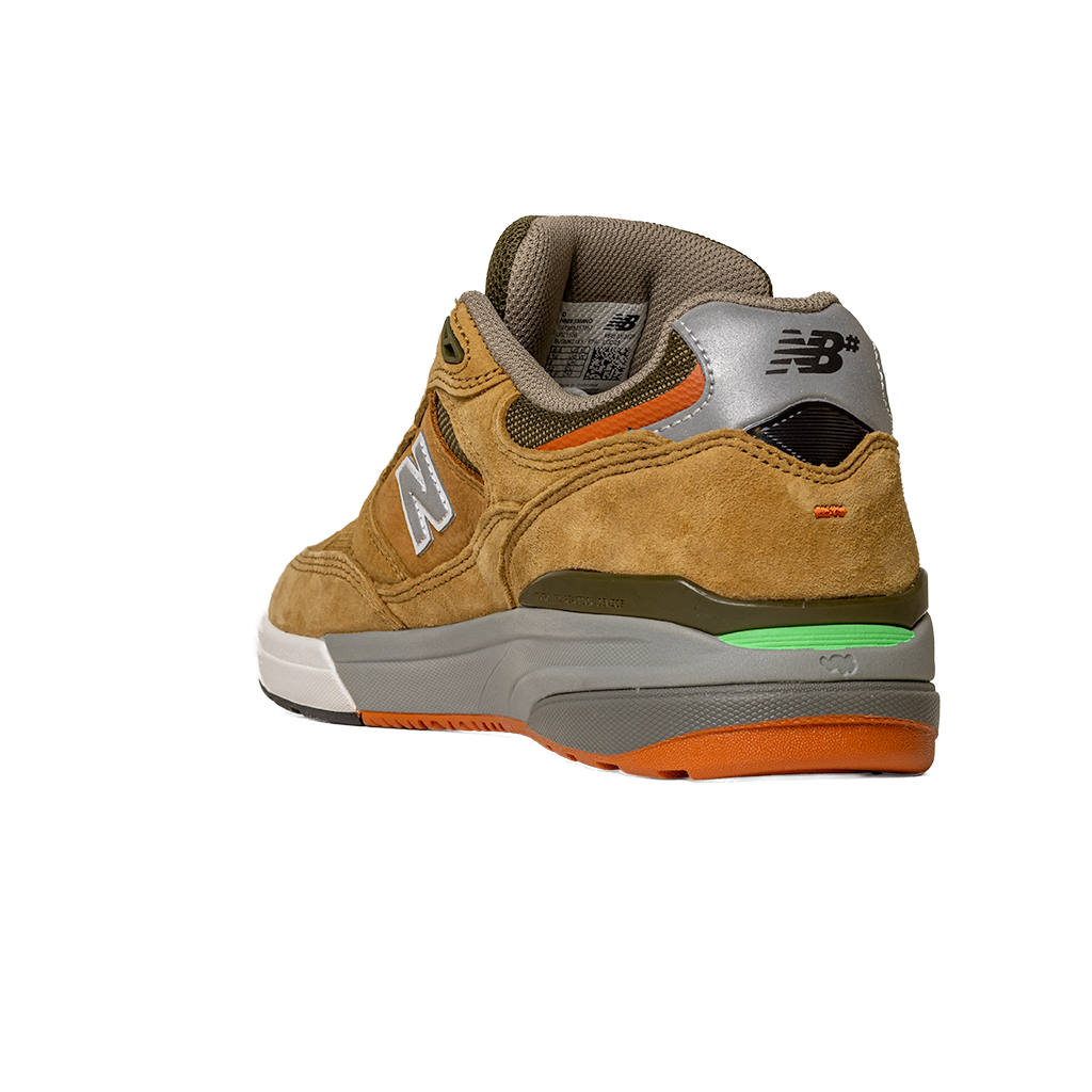The 933 MNO Andrew Reynolds Brown Grey New Balance Numeric Skateboarding Shoes feature tan suede, a gray and silver heel, orange and green accents, a light brown midsole, and the NB logo on the heel tab.