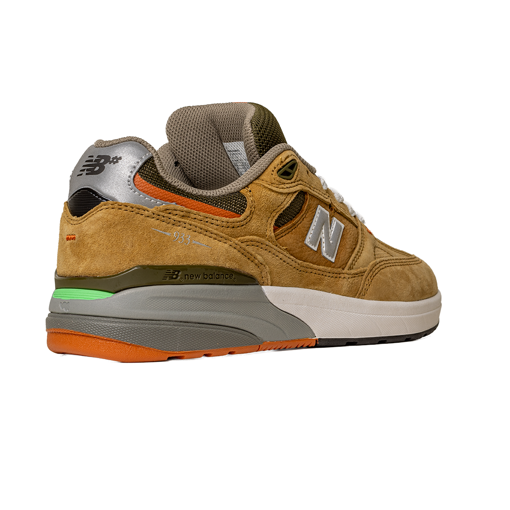The 933 MNO Andrew Reynolds Brown Grey New Balance Numeric Skateboarding Shoes feature tan suede, gray and orange accents, white laces, a multicolored green/gray/orange/white sole, an N logo on the side, and New Balance branding on the heel.