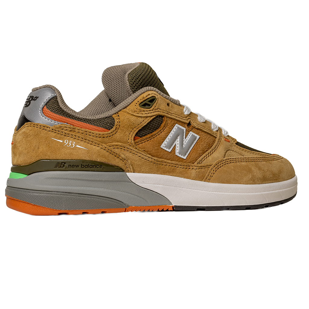 The 933 MNO Andrew Reynolds Brown Grey New Balance Numeric Skateboarding Shoes feature brown and tan suede, orange, green, and gray accents, white laces, a mesh toe box, chunky sole, and a silver N logo with white trim.