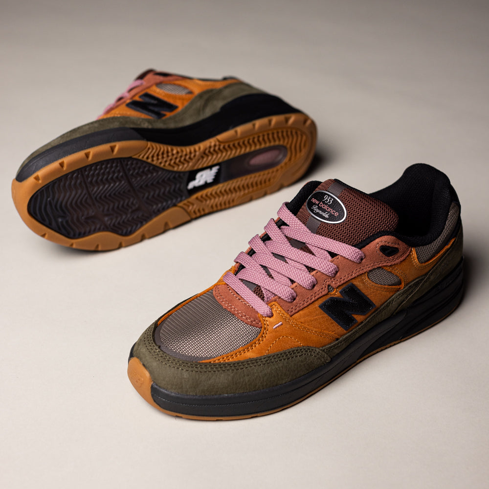 Two Mike Gigliotti True Brown Candy Pink 933 LOT New Balance Numeric suede skateboarding shoes with earthy brown, green, and orange hues, pink laces, and gum soles deliver heritage design and premium cushioning inspired by iconic skate style.